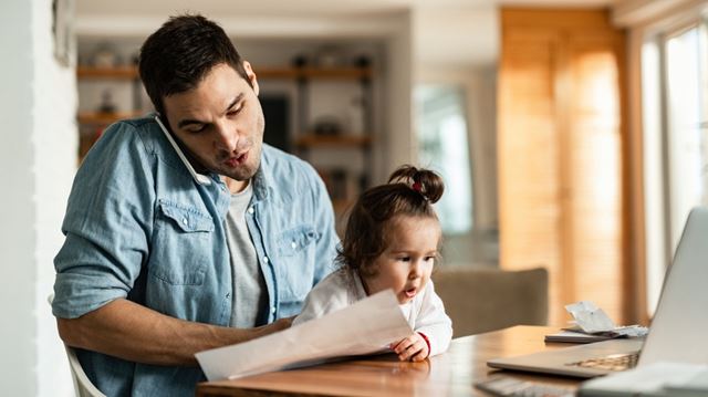 Man on phone with young daughter